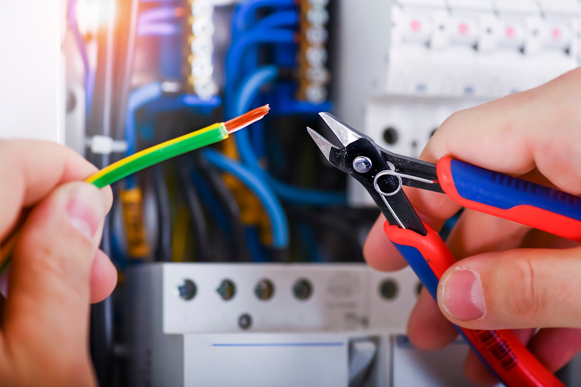 Electrician cutting wires detail.